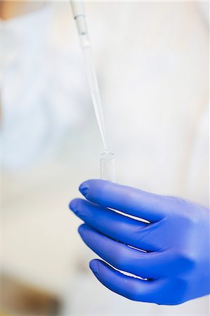 simsearch:6102-06470932,k - Close-up of technician holding pipette during research in laboratory Stock Photo - Premium Royalty-Free, Code: 6102-08951878