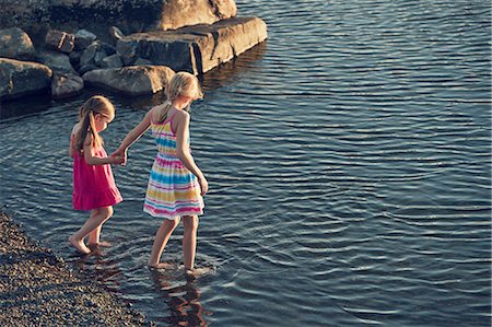 dress wading water - Girls wading in lake Stock Photo - Premium Royalty-Free, Code: 6102-08952062