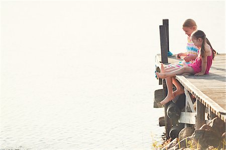simsearch:6102-08952062,k - Girls sitting on pier by lake Stock Photo - Premium Royalty-Free, Code: 6102-08952069