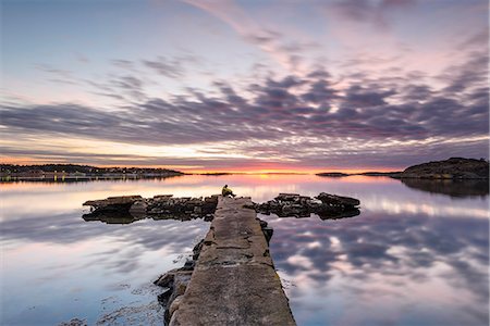 people sitting on dock - Sunset at sea Stock Photo - Premium Royalty-Free, Code: 6102-08994753