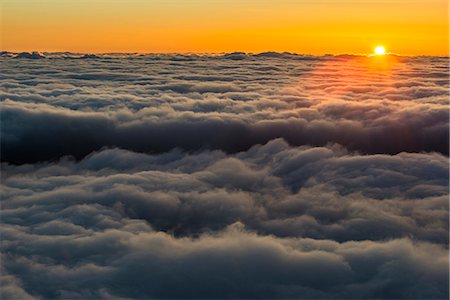 Sunset above clouds Stock Photo - Premium Royalty-Free, Code: 6102-08994805