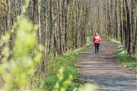 simsearch:6102-08994936,k - Woman Nordic walking in spring forest Photographie de stock - Premium Libres de Droits, Code: 6102-08994989