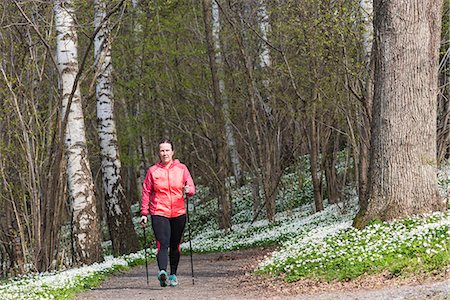 simsearch:6102-08994936,k - Woman Nordic walking in spring forest Photographie de stock - Premium Libres de Droits, Code: 6102-08994991
