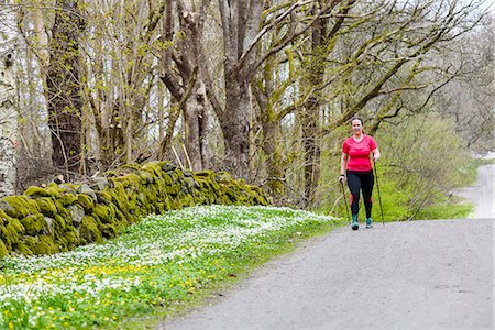 simsearch:6102-08994936,k - Woman Nordic walking in spring forest Photographie de stock - Premium Libres de Droits, Code: 6102-08994998