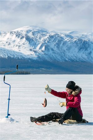 european woman holding fish - Woman ice fishing Stock Photo - Premium Royalty-Free, Code: 6102-08994907