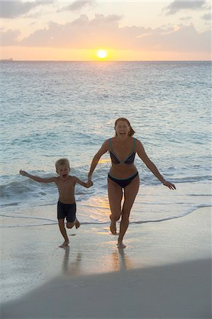 family holding hands on beach at sundown - Mother with son on beach Stock Photo - Premium Royalty-Free, Code: 6102-08995125