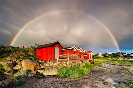 Rainbow above wooden buildings Stock Photo - Premium Royalty-Free, Code: 6102-08995838