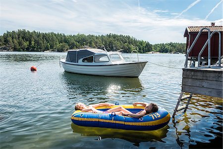 Girls relaxing in inflatable boat Stock Photo - Premium Royalty-Free, Code: 6102-08995922