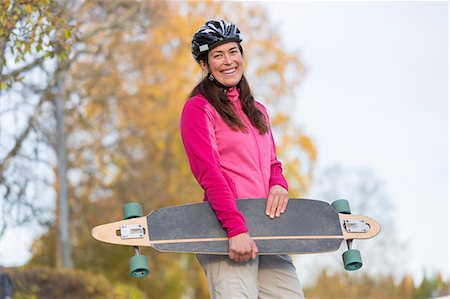 simsearch:6102-08996464,k - Woman carrying longboard Foto de stock - Royalty Free Premium, Número: 6102-08996463