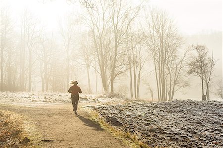 Woman jogging at foggy morning Stock Photo - Premium Royalty-Free, Code: 6102-08996536