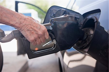 petrol and gas cars - Woman filling car at a gas station Stock Photo - Premium Royalty-Free, Code: 6105-05395912