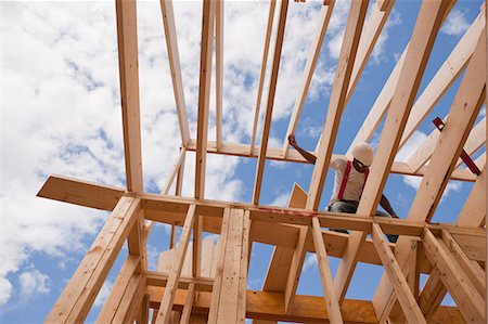 framing (activity) - Low angle view of a carpenter adjusting roof framing Stock Photo - Premium Royalty-Free, Code: 6105-05396072