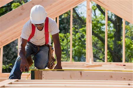 Carpenter measuring joists and beams Stock Photo - Premium Royalty-Free, Code: 6105-05396098