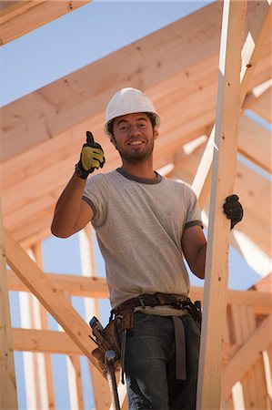 Carpenter showing thumbs up sign and smiling Stock Photo - Premium Royalty-Free, Code: 6105-05396102