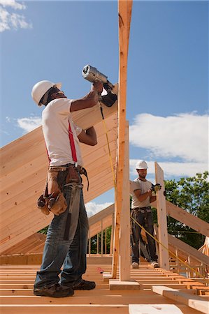 simsearch:6105-05396053,k - Carpenters nailing and adjusting roof rafters Stock Photo - Premium Royalty-Free, Code: 6105-05396107