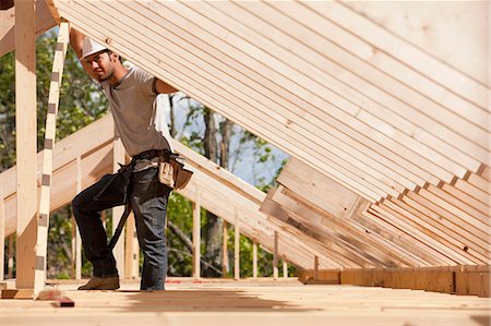 simsearch:6105-06043027,k - Carpenter placing roof framing Stock Photo - Premium Royalty-Free, Code: 6105-05396110