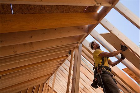 simsearch:614-09198248,k - Hispanic carpenter working at a house under construction Stock Photo - Premium Royalty-Free, Code: 6105-05396259