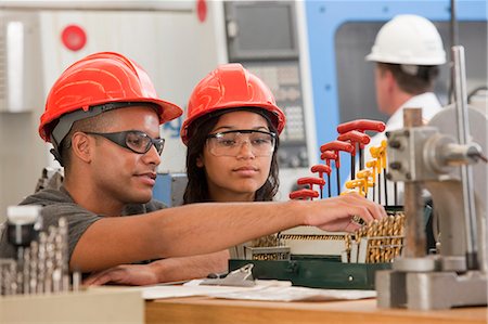 student and professor - Engineering students selecting drill bits for a CNC machine Stock Photo - Premium Royalty-Free, Code: 6105-05396353