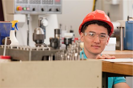 engineering students - Engineering student studying in a machine lab Stock Photo - Premium Royalty-Free, Code: 6105-05396354