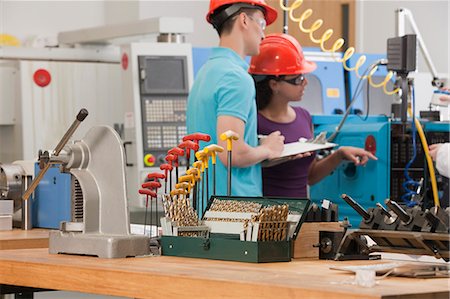 Engineering students working in a CNC machine lab Stock Photo - Premium Royalty-Free, Code: 6105-05396362