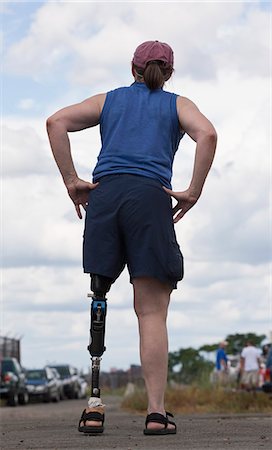 prosthetic leg - Woman with prosthetic leg standing on the road Stock Photo - Premium Royalty-Free, Code: 6105-05396335