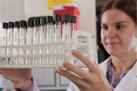 simsearch:6105-05396454,k - Scientist holding a rack of test tubes in the laboratory of water treatment plant Stock Photo - Premium Royalty-Free, Code: 6105-05396453