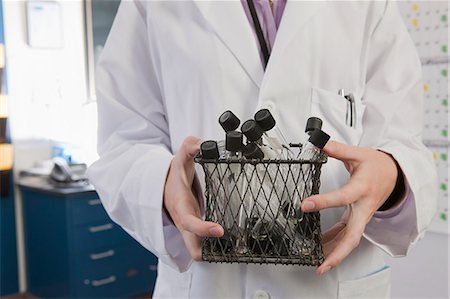 simsearch:6105-05396454,k - Scientist holding a container of test tubes in the laboratory of water treatment plant Stock Photo - Premium Royalty-Free, Code: 6105-05396450