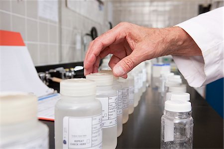 simsearch:6105-05396454,k - Scientist selecting sample bottles in the laboratory of water treatment plant Stock Photo - Premium Royalty-Free, Code: 6105-05396455