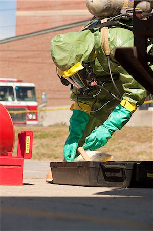 HazMat firefighter preparing decontamination tray Stock Photo - Premium Royalty-Free, Code: 6105-05396499