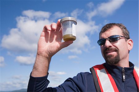 sunglasses boat - Scientist collecting samples of algae in a boat Stock Photo - Premium Royalty-Free, Code: 6105-05396416