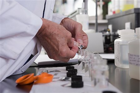 Scientist adding precise sample of solid chemicals to sample vials in the laboratory of water treatment plant Stock Photo - Premium Royalty-Free, Code: 6105-05396432