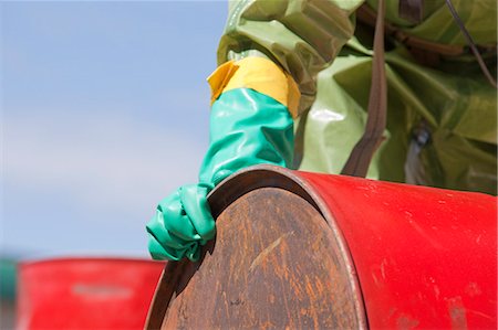 simsearch:6105-06703091,k - HazMat firefighter moving a chemical drum Stock Photo - Premium Royalty-Free, Code: 6105-05396505