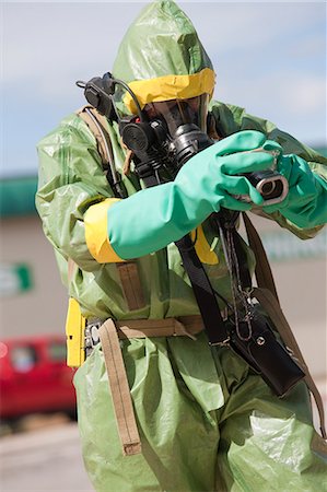 fire protection suit - HazMat firefighter working with a camera to log the accident Stock Photo - Premium Royalty-Free, Code: 6105-05396515