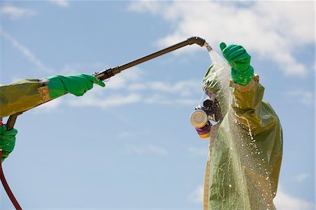 fire protection suit - HazMat firefighter getting decontamination wash Stock Photo - Premium Royalty-Free, Code: 6105-05396533