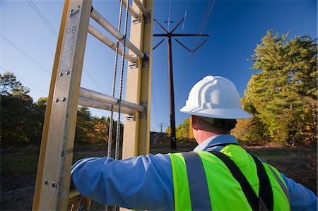 simsearch:6105-05396624,k - Engineer holding ladder to install equipment on power poles Stock Photo - Premium Royalty-Free, Code: 6105-05396626