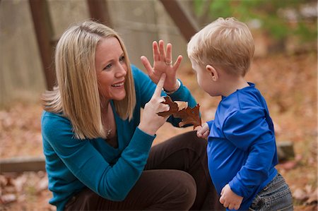 Woman signing the word 'Leaf' in American Sign Language while communicating with her son Stock Photo - Premium Royalty-Free, Code: 6105-05396772