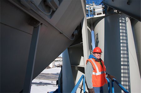 silo pipe picture - Engineer standing on inspection platform at materials plant Stock Photo - Premium Royalty-Free, Code: 6105-05396862