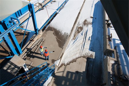 Two engineers monitoring an industrial plant in winter Stock Photo - Premium Royalty-Free, Code: 6105-05396864