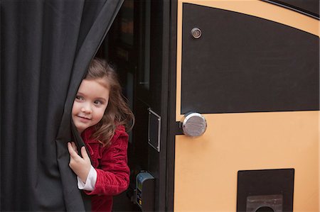 person standing to bus - Girl peeking out from a bus Stock Photo - Premium Royalty-Free, Code: 6105-05396821