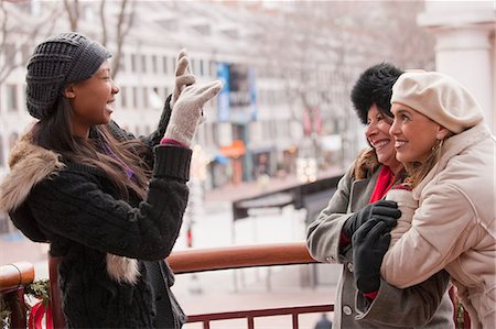 family at market - Brazilian woman taking picture of her mother and grandmother with a mobile phone, Boston, Massachusetts, USA Stock Photo - Premium Royalty-Free, Code: 6105-05396839