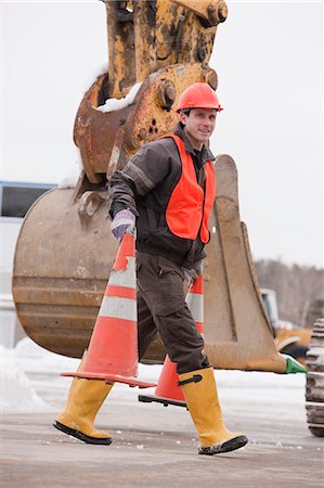 Transportation engineer moving traffic cones at a construction site Stock Photo - Premium Royalty-Free, Code: 6105-05396946