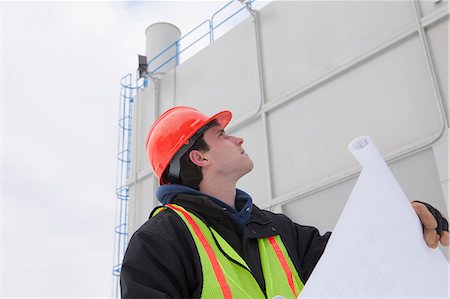 power plant - Engineers holding a blueprint at a chemical plant Stock Photo - Premium Royalty-Free, Code: 6105-05396982