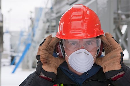 Engineer with protective mask and ear protectors Fotografie stock - Premium Royalty-Free, Codice: 6105-05396986