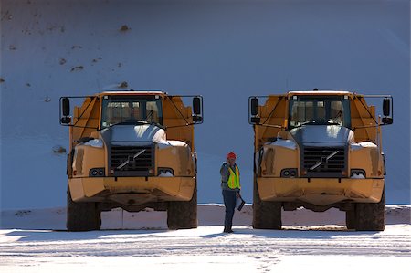 engineers inspecting at construction site - Engineer on phone during inspection of earth movers at a construction site Stock Photo - Premium Royalty-Free, Code: 6105-05396916