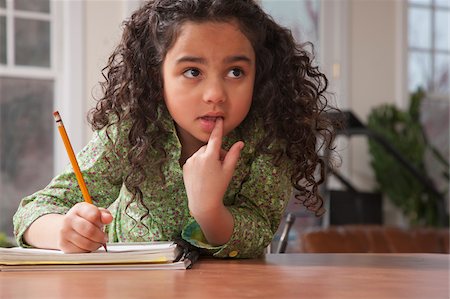 pencil (writing instrument) - Hispanic girl doing her school work Stock Photo - Premium Royalty-Free, Code: 6105-05397185