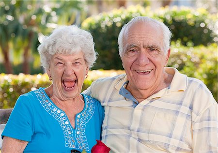 picture of two people on a park bench - Couple smiling in a park Stock Photo - Premium Royalty-Free, Code: 6105-05397131