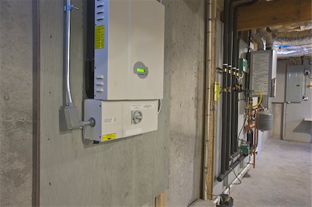 energy efficient - Photovoltaic inverter and transfer switch in the basement of a Green Technology Home Stock Photo - Premium Royalty-Free, Code: 6105-05397231