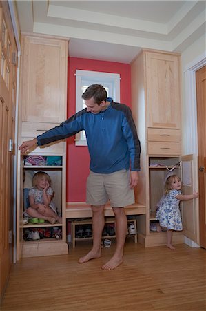 shoes in closet - Girls playing with their father in a disability accessible home Stock Photo - Premium Royalty-Free, Code: 6105-05397300