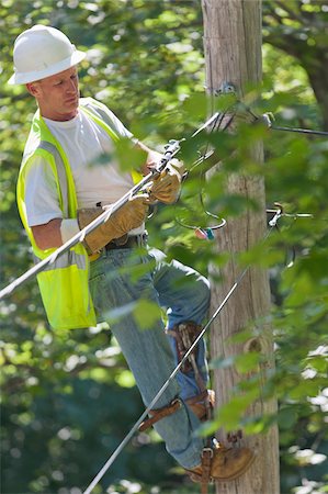 simsearch:6105-05396613,k - Lineman on a pole working on phone and cable wires Stock Photo - Premium Royalty-Free, Code: 6105-05953740