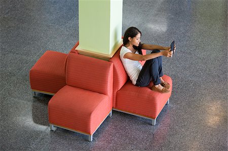 digital communication - Engineering student reading a digital tablet in student lounge Stock Photo - Premium Royalty-Free, Code: 6105-05953769